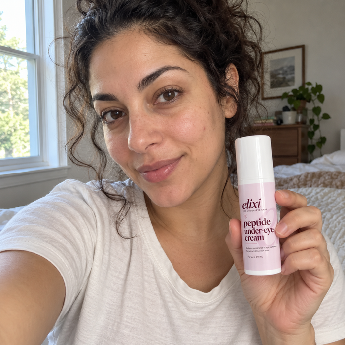 Customer photo showing a woman holding Elixi Peptide Under-Eye Cream